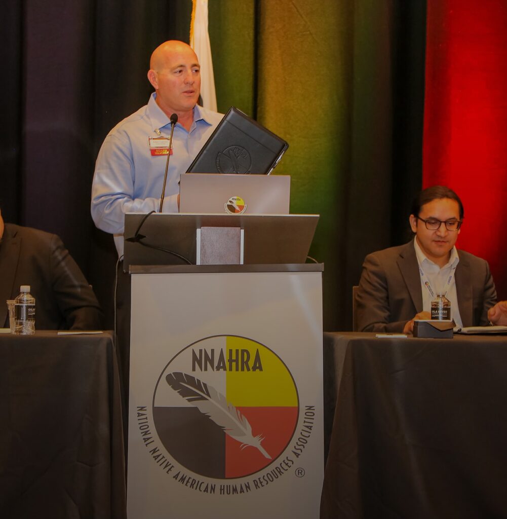 Man speaking at a NNAHRA conference