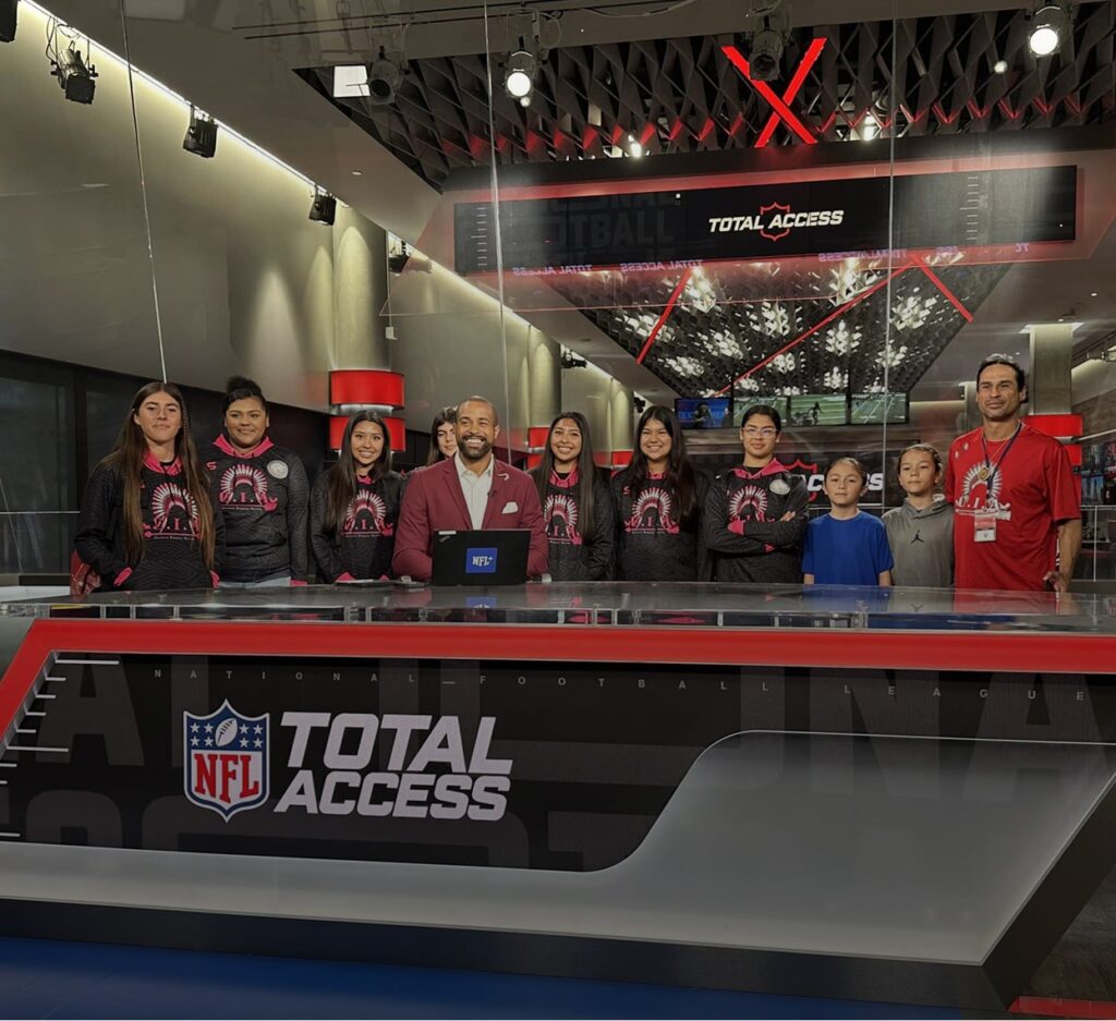 Native Youth Foundation members behind the NFL Total Access desk counter