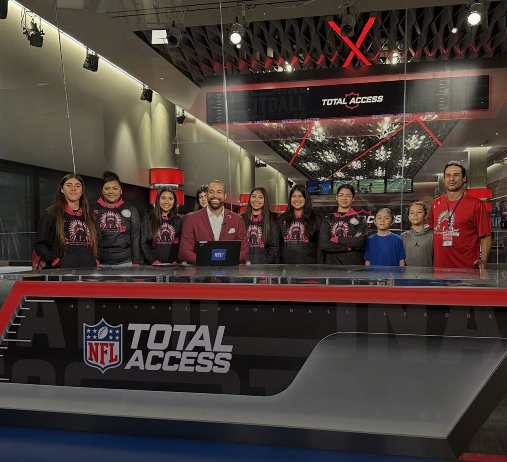 Native Youth Foundation members behind the NFL Total Access desk counter